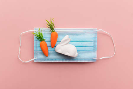 Easter springtime coronavirus background. Protective face mask with easter decorationsの写真素材