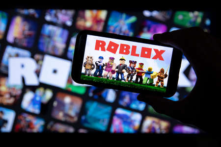 LONDON, UK - March 2021: Person holding a smartphone with Roblox game logoのeditorial素材