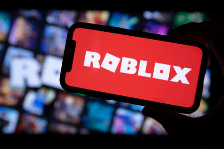 LONDON, UK - March 2021: Person holding a smartphone with Roblox game logoのeditorial素材