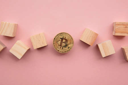 Bitcoin cryptocurrency coin blockchain technology concept. Coin with wood block