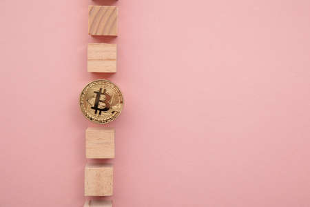 Bitcoin cryptocurrency coin blockchain technology concept. Coin with wood block