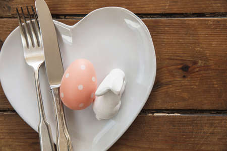 Easter meal table decorated with springtime easter bunny and easter egg