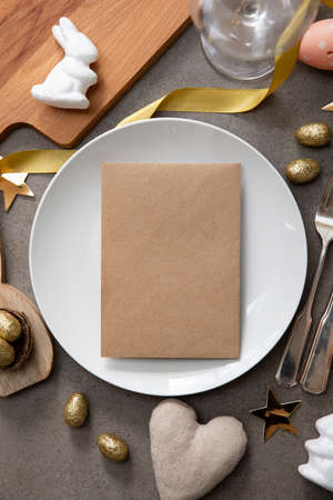 Happy easter celebration background. Decorated table with blank menuの写真素材