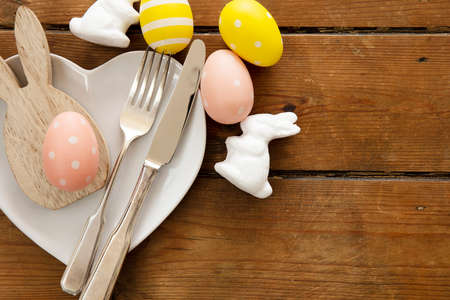 Easter meal table decorated with springtime easter bunny and easter eggs