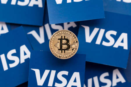 LONDON, UK - March 2021: Bitcoin cryptocurrency on Visa financial service logoのeditorial素材
