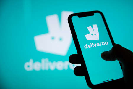 LONDON, UK - April 2021: Deliveroo takeaway delivery service logo on a phoneのeditorial素材