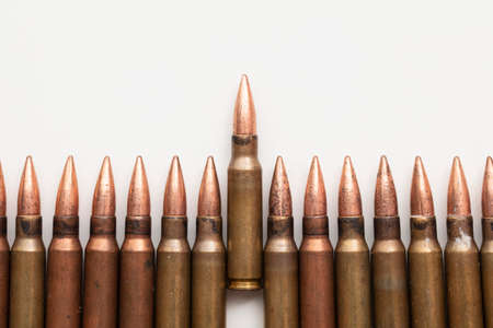 Close up of a line of bullets against a white background
