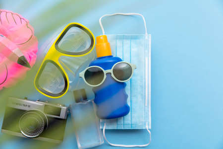 Summer vacation background with protective mask and holiday itemsの写真素材
