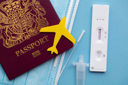 Coronavirus travel passport. Aeroplane on a passport with protective face maskの写真素材