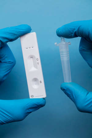 Close up of a person using coronavirus covid-19 rapid antigen home testing kitの写真素材