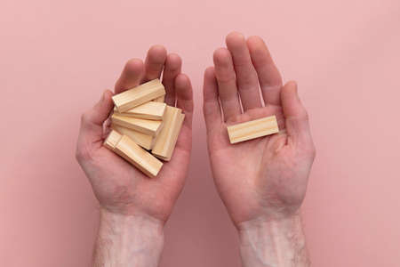 Hand choosing a wooden block from a set. Business choice conceptの写真素材