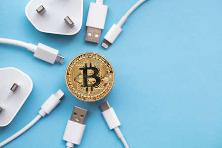 bitcoin cryptocurrency energy consumption concept. Gold coin with electric plugの写真素材