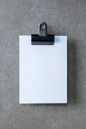 Blank white invite or postcard with an office clipの写真素材
