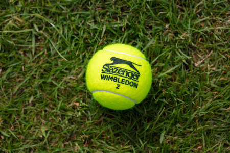 LONDON, UK - June 2021: Official wimbledon tennis Slazenger brand ball on grassのeditorial素材