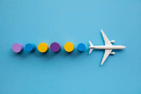 Travel background with a toy airplane and colourful circular blocksの写真素材