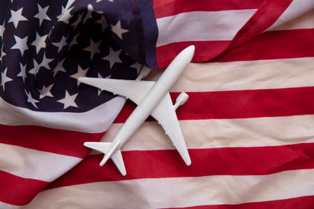 United states flight background. Airplane toy on a starts and stripes flagの写真素材