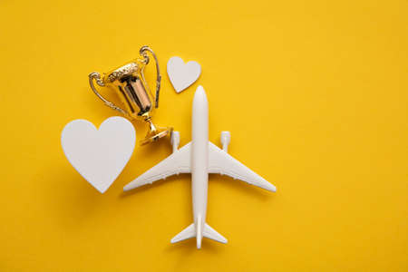Airplane travel awards. Aviation business satisfaction. Toy airplane with gold trophy
