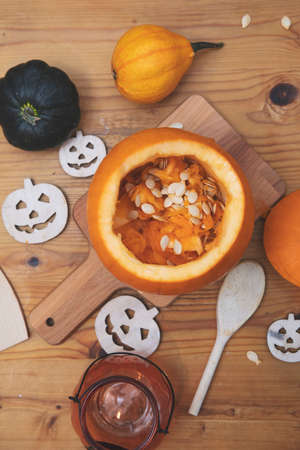 Overhead view of an orange pumpkin being carved into a lantern for halloween decorationの写真素材