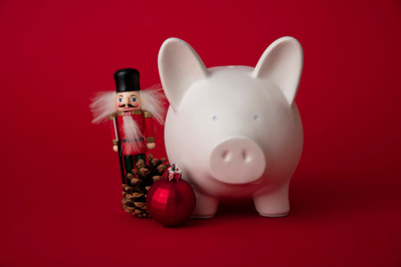 Festive financial savings concept. Piggy bank with Christmas decorations
