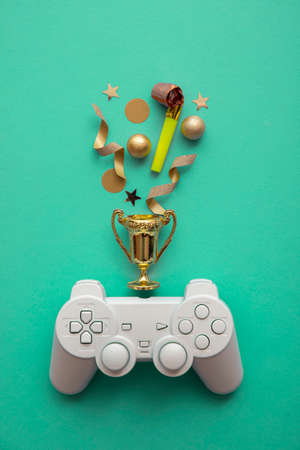 Video game esports winning competition background. Game controller with gold winning trophy
