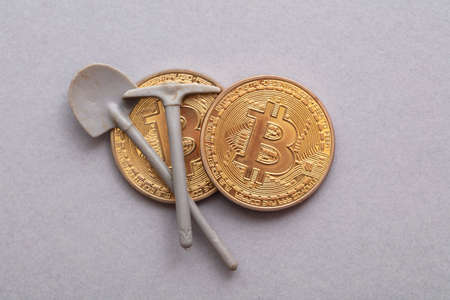 BItcoin crypto currency mining. Bitcoin gold coin with a mining pickaxeの写真素材