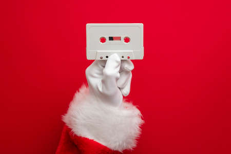 Father Christmas holding a retro music cassette tape. Christmas party conceptの写真素材