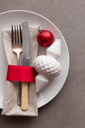 Festive Christmas meal background. Plate with knife and fork and Christmas decorationsの写真素材