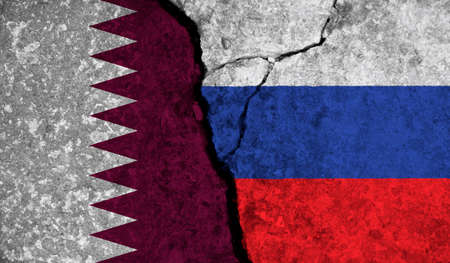 Political relationship between Qatar and russia. National flags on cracked concrete backgroundの写真素材