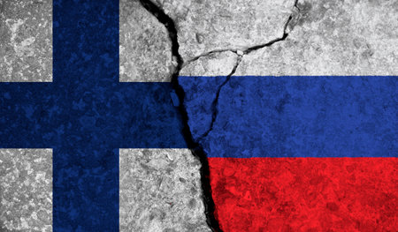 Political relationship between Finland and russia. National flags on cracked concrete backgroundの写真素材