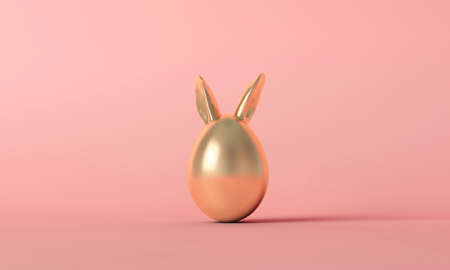 Gold easter egg with cute spring bunny ears on a pastel pink background. 3D Renderingの写真素材