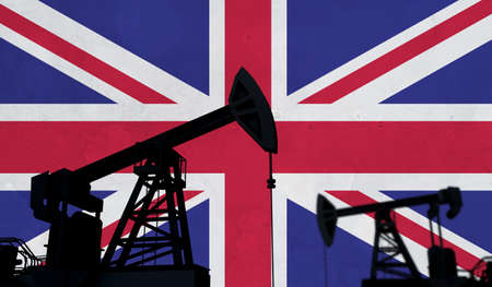 Oil and gas industry background. Oil pump silhouette against united kingdom flag. 3D Rendering