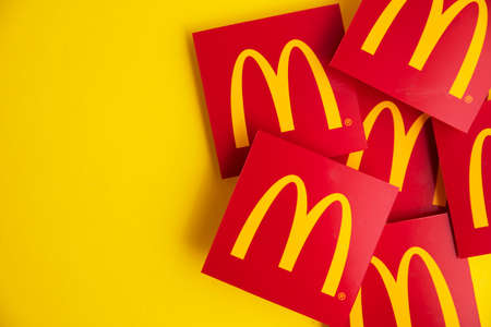LONDON, UK - June 2022: McDonalds iconic logo against a yellow background. McDonalds is a global fast food businessのeditorial素材
