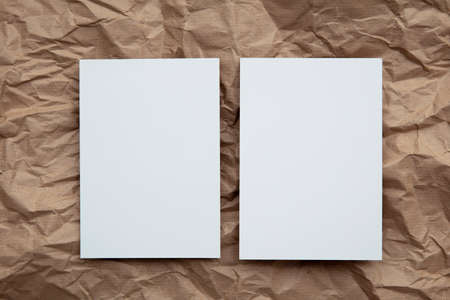 Blank white invitation letter template mock up on crumpled brown paperの写真素材