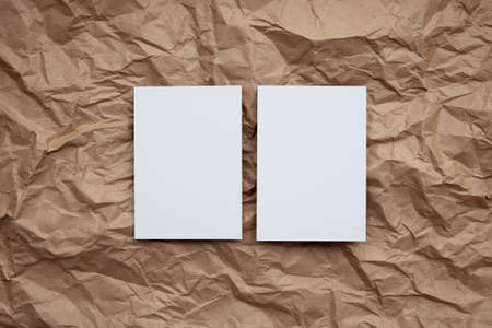 Blank white invitation letter template mock up on crumpled brown paper