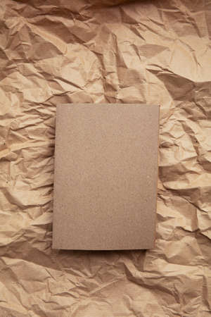 Blank invitation letter template mock up on crumpled brown paperの写真素材