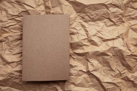 Blank invitation letter template mock up on crumpled brown paperの写真素材