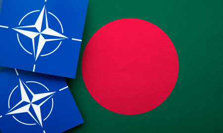 LONDON, UK - August 2022: NATO North Atlantic Treaty Organization military alliance logo on a Bangladesh flagのeditorial素材