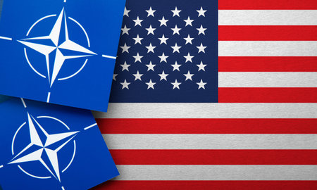 LONDON, UK - August 2022: NATO North Atlantic Treaty Organization military alliance logo on a USA flagのeditorial素材