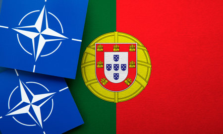 LONDON, UK - August 2022: NATO North Atlantic Treaty Organization military alliance logo on a Portugal flagのeditorial素材