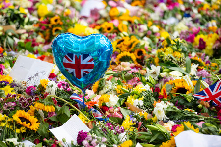 LONDON, UK - September 2022: Thousands of flowers, cards and messages are laid in Green park in...
