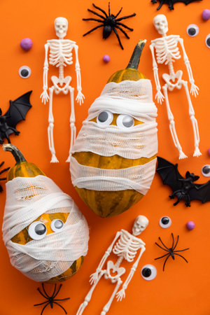 Cute halloween background with mummy pumpkins, skeletons and spidersの写真素材