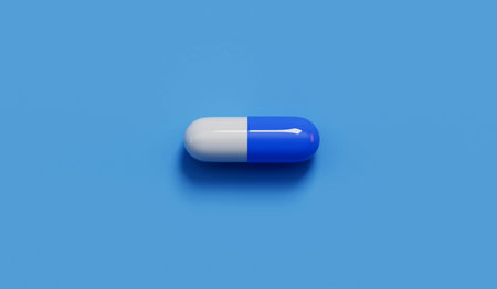 medical pill capsules on a blue background. Healthcare concept. 3D Renderingの写真素材