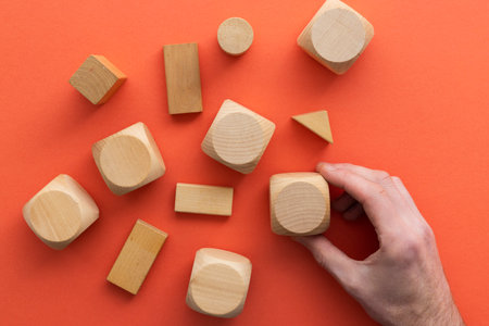Hand choosing a wooden block from a set. Business choice concept