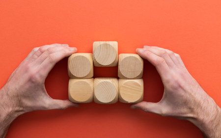 Hand choosing a wooden block from a set. Business choice conceptの写真素材