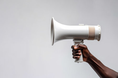 African american persons hand holding an announcement megaphoneの素材