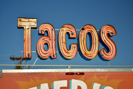 A mexican taco illuminated sign above a street food vendor truck.の素材