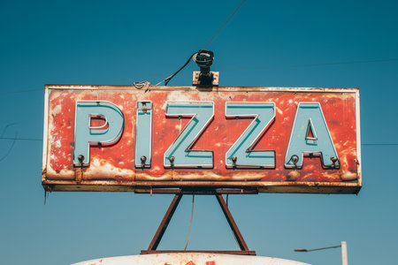A pizza illuminated sign above a street food vendor truckの素材
