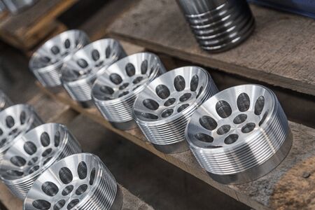 Billet obtained on lathe from steel. Many of same parts on pallets in industrial factory. Expect further processing. Metal industry products, workpieces. Steel products to automotive industry.の写真素材