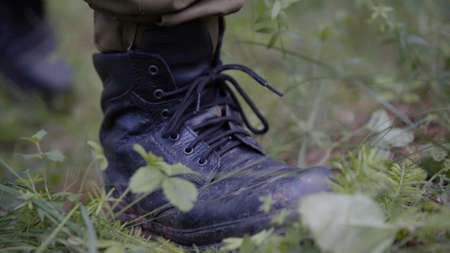 Man walking on mossy forest path. Outdoor activity concept. Summer hiking in wilderness area....