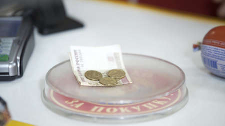 Pay money to cashier in supermarket. Dispensing change from register cash drawer giving coins and...